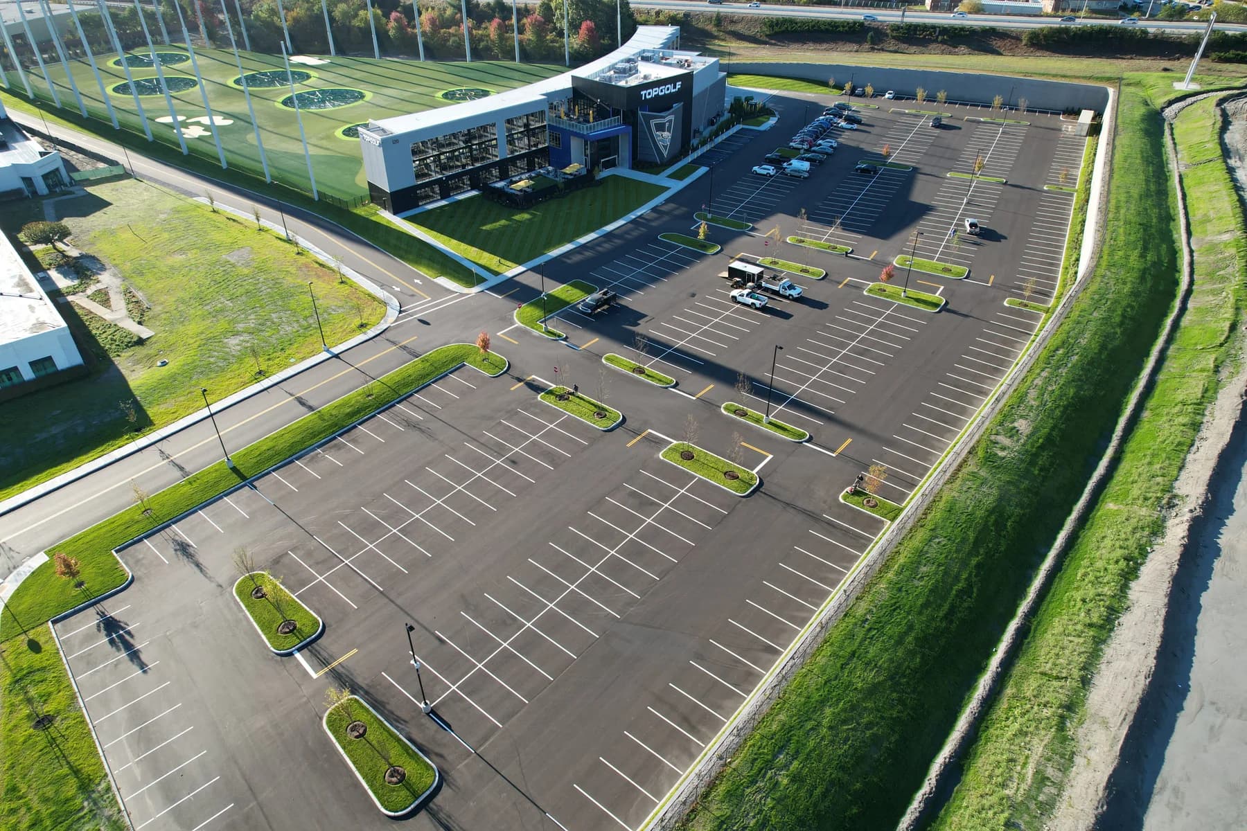 Aerial view of a large commercial parking lot — the kind of large-lot throughput Coastal Corp clears in a single pass.