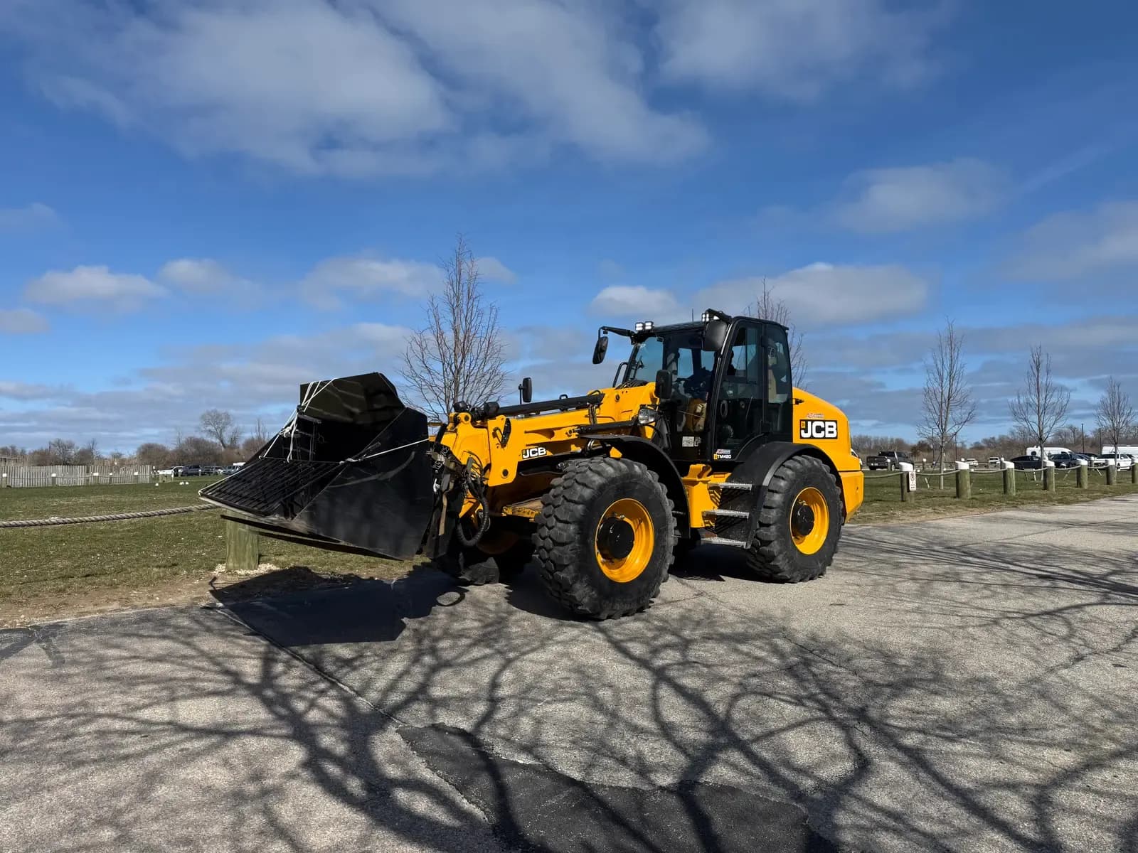 A Coastal Corp JCB TM420 articulated telescopic wheel loader with a bucket attachment.
